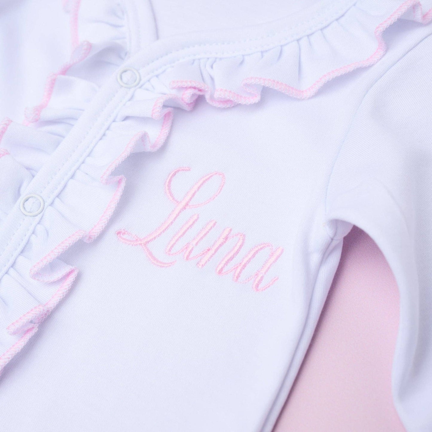 Magnolia Baby White Ruffle Footie with Pink Trim